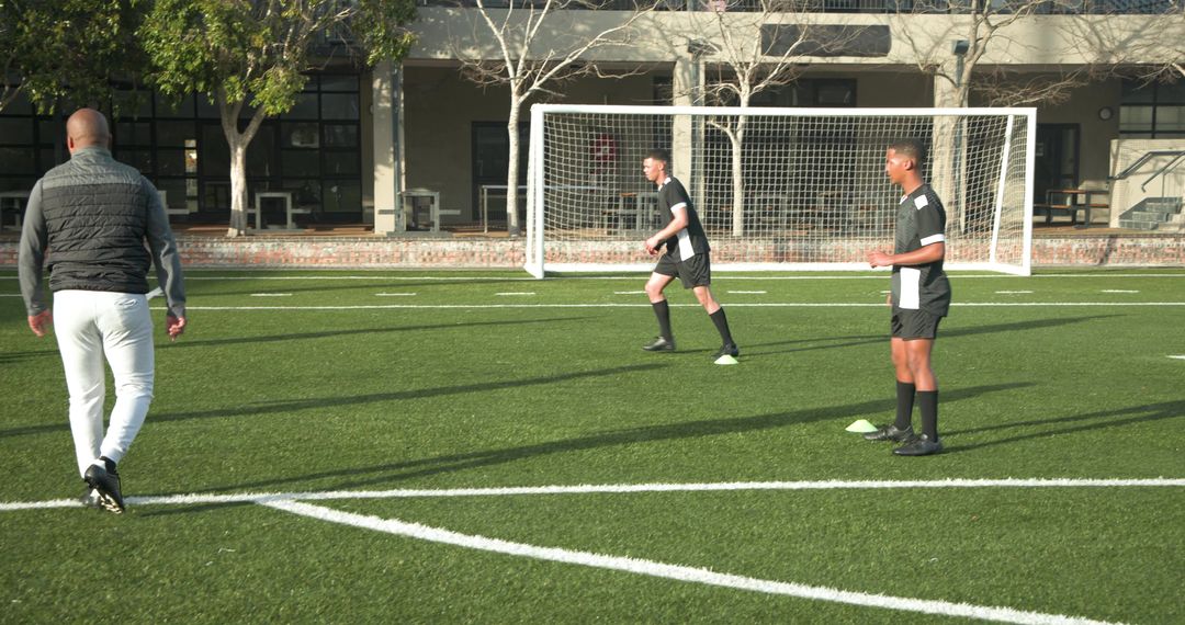 Soccer Team Practicing Passing Drills on Sunny Field