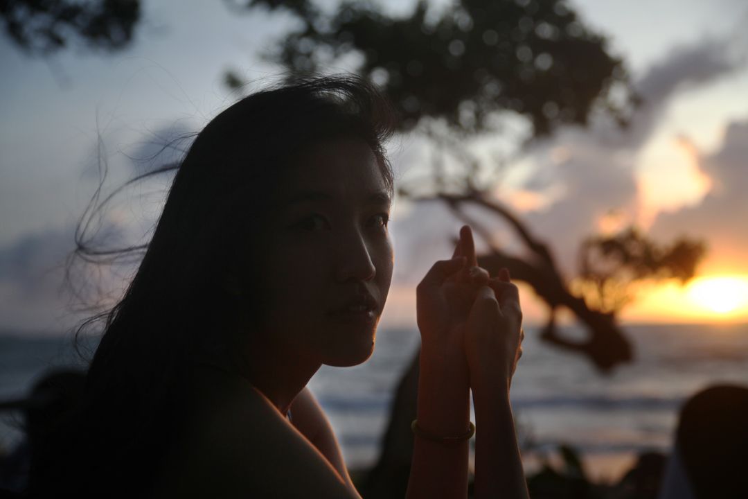 Woman Enjoying Beach Sunset with Silhouette - Free Images, Stock Photos and Pictures on Pikwizard.com