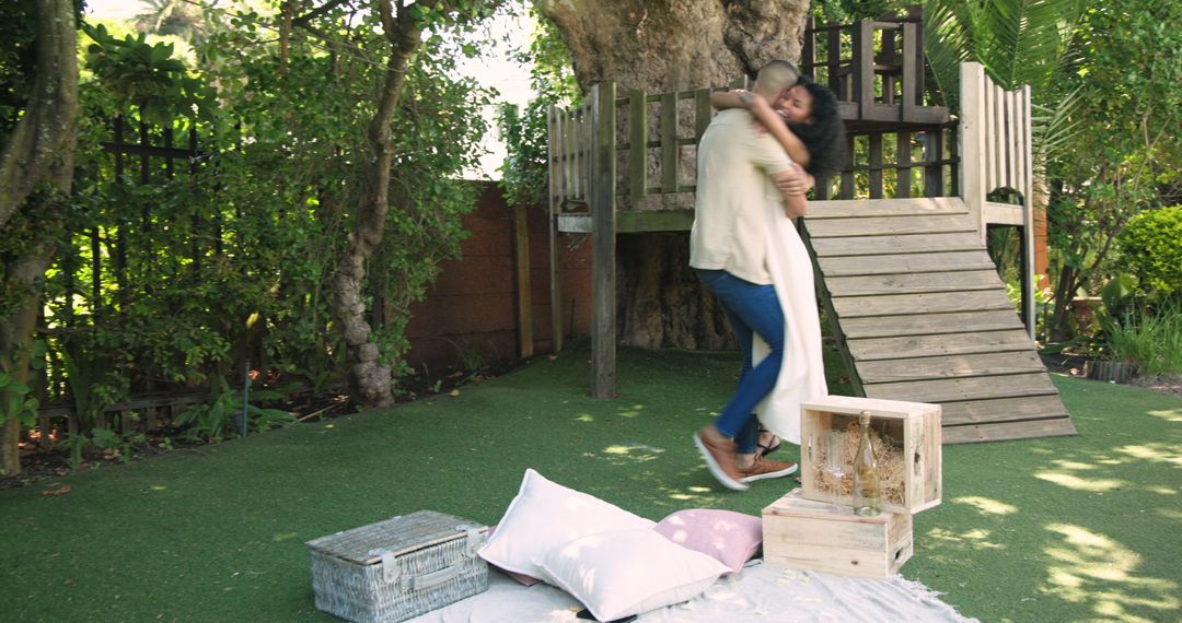 Couple Embracing in Playful Backyard Surrounded by Nature