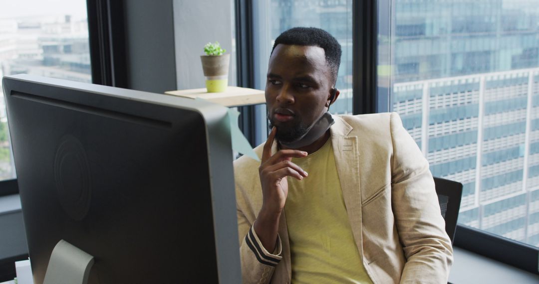 Businessman in Office with Mask Using Computer during Pandemic