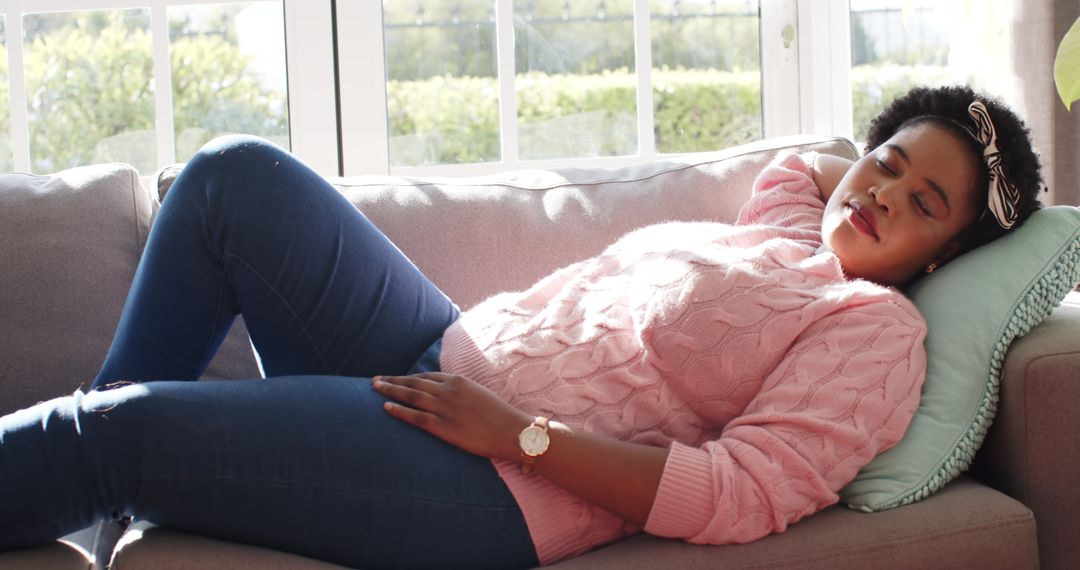 African American Woman Enjoying Relaxing Midday Rest on Couch