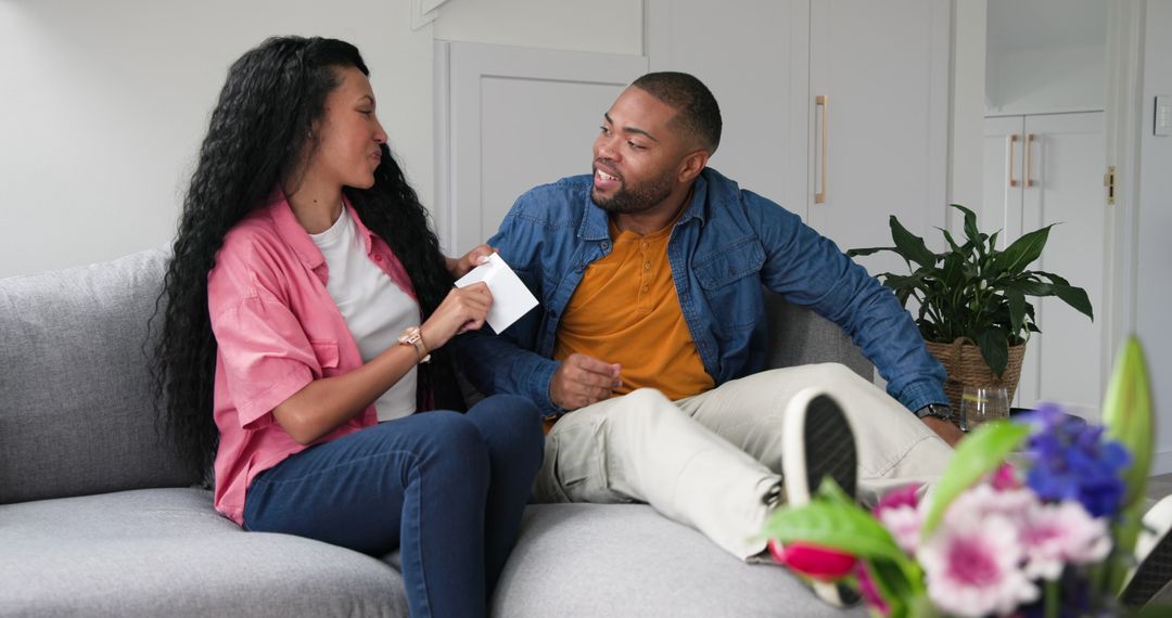 Couple Joyfully Sharing Pregnancy Announcement on Couch