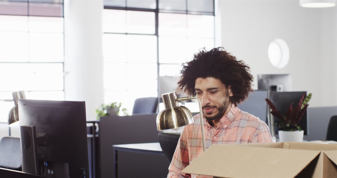 Happy Professional Unpacking in Modern Office Workspace