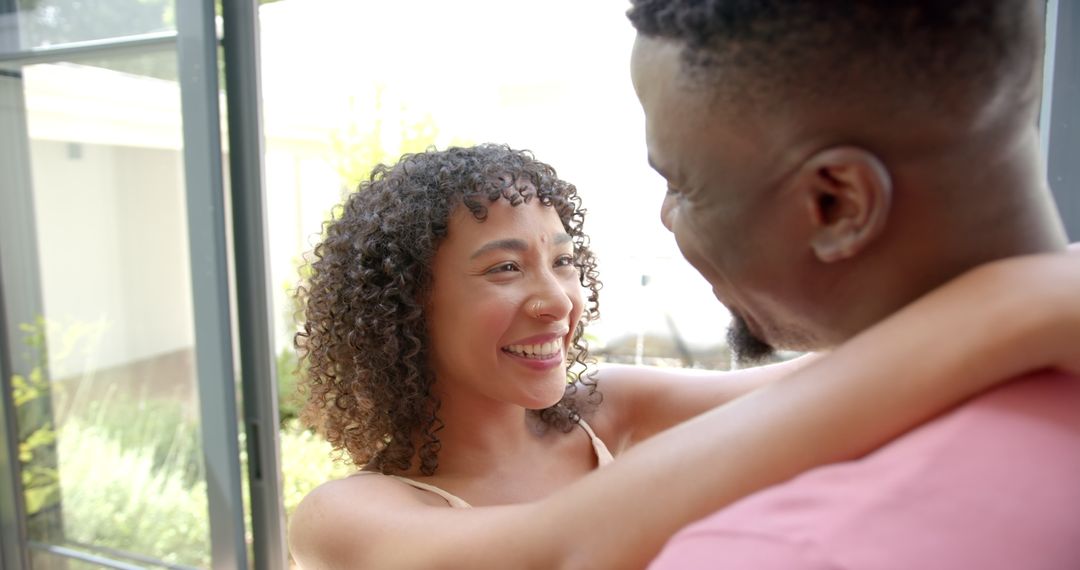Smiling Couple Embracing in Sunlit Room