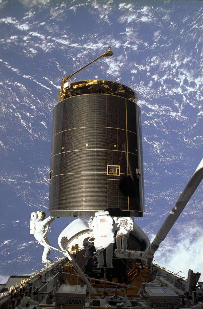 Astronauts capturing satellite during STS-49 mission with Earth background - Free Images, Stock Photos and Pictures on Pikwizard.com