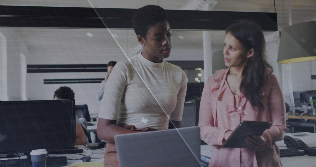 Two Professionals Discussing Work Tasks in Modern Office Environment