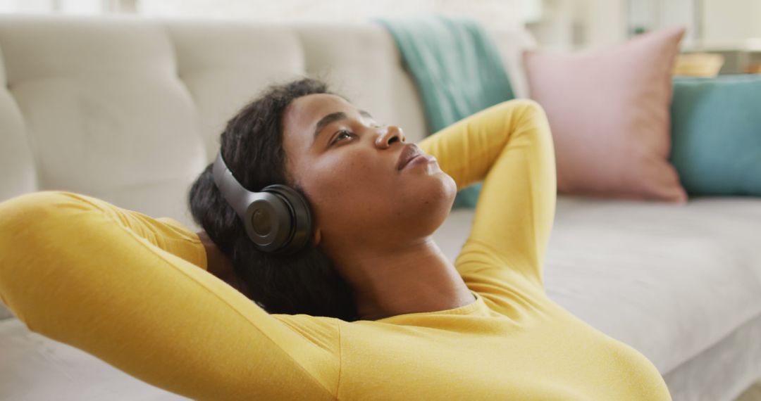 Woman Listening to Music with Headphones Relaxing on Couch at Home - Free Images, Stock Photos and Pictures on Pikwizard.com