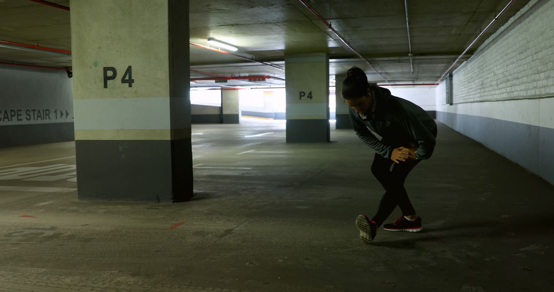 Woman Stretching in Undercover Parking Garage - Free Images, Stock Photos and Pictures on Pikwizard.com