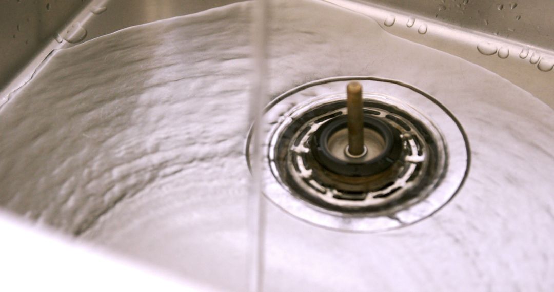 Close-Up of Clean Water Draining in Steel Kitchen Sink - Free Images, Stock Photos and Pictures on Pikwizard.com