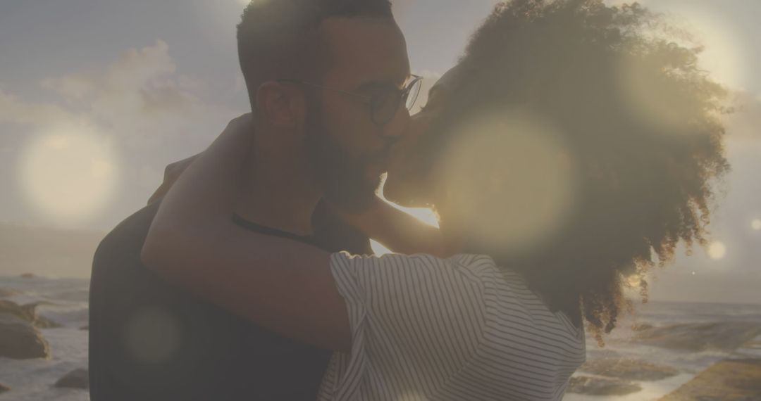 Romantic Couple Kissing by Ocean at Sunset - Free Images, Stock Photos and Pictures on Pikwizard.com