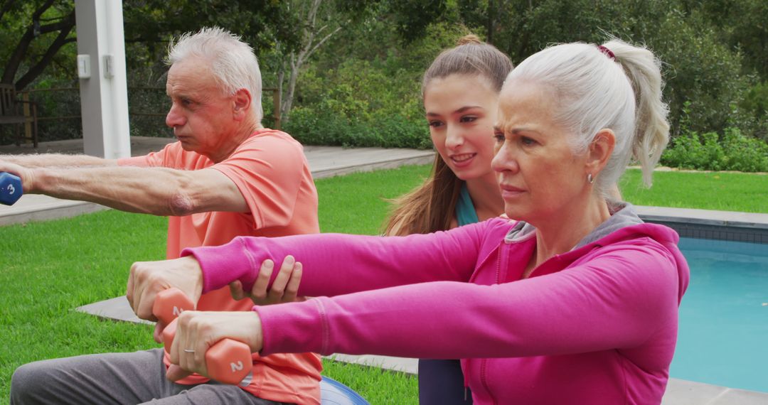 Personal Trainer Coaching Seniors During Outdoor Workout with Dumbbells - Free Images, Stock Photos and Pictures on Pikwizard.com