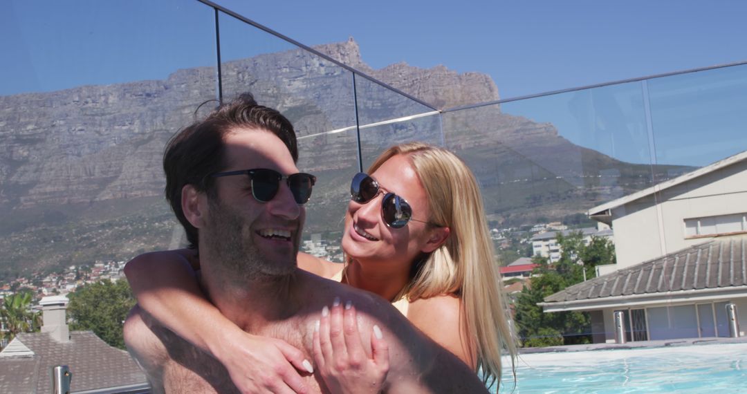 Happy Couple Relaxing at Pool with Scenic Mountains in Background - Free Images, Stock Photos and Pictures on Pikwizard.com