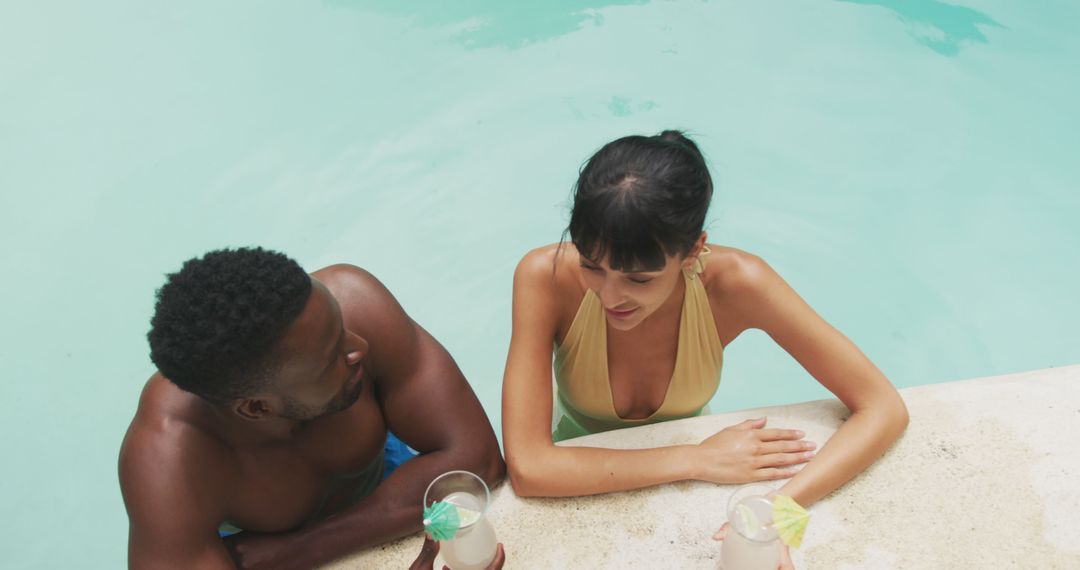 Couple Relaxing in Pool with Tropical Drinks - Free Images, Stock Photos and Pictures on Pikwizard.com