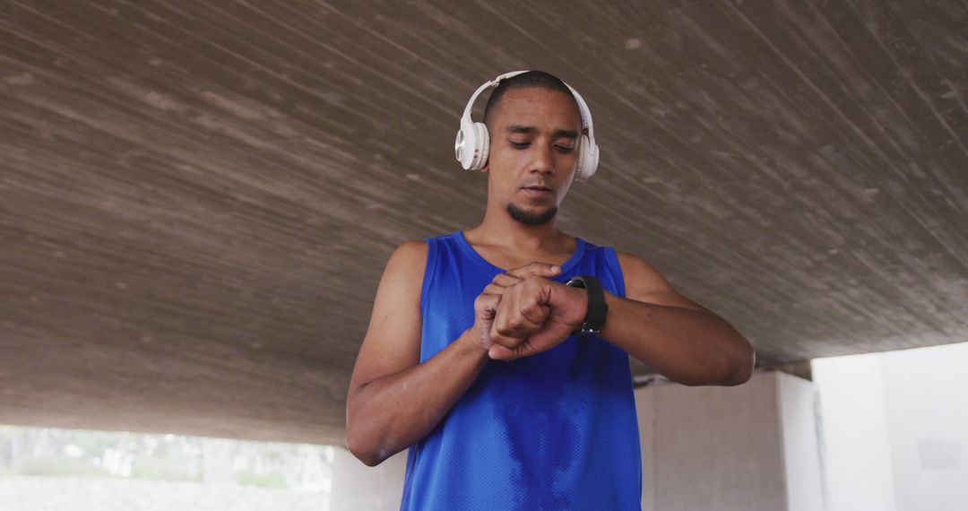 Man Checking Smartwatch During Workout Under Bridge - Free Images, Stock Photos and Pictures on Pikwizard.com