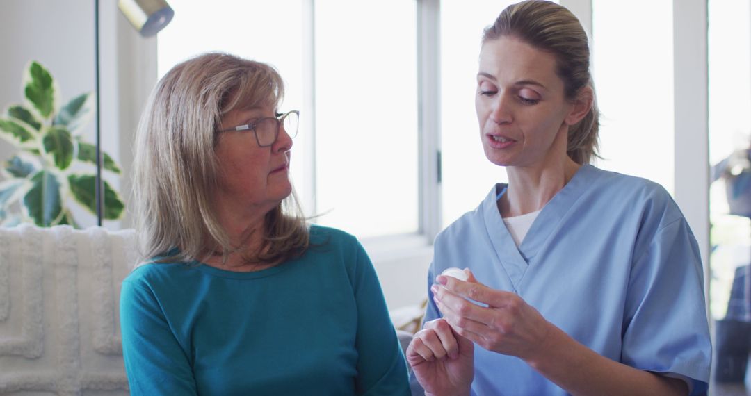 Healthcare Professional Explaining Medication to Senior Woman - Free Images, Stock Photos and Pictures on Pikwizard.com