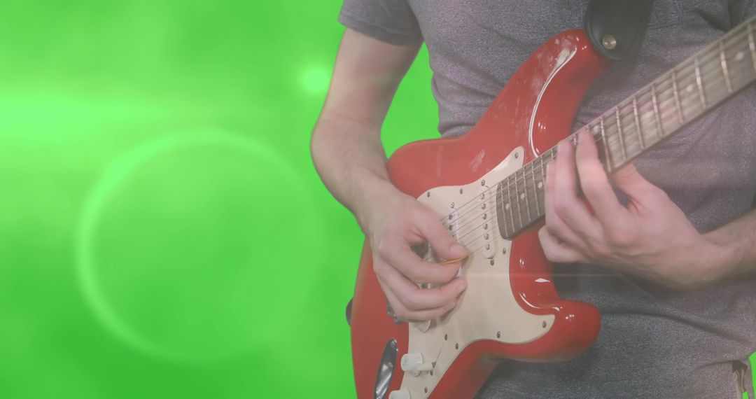 Man Playing Electric Guitar on Green Screen Background