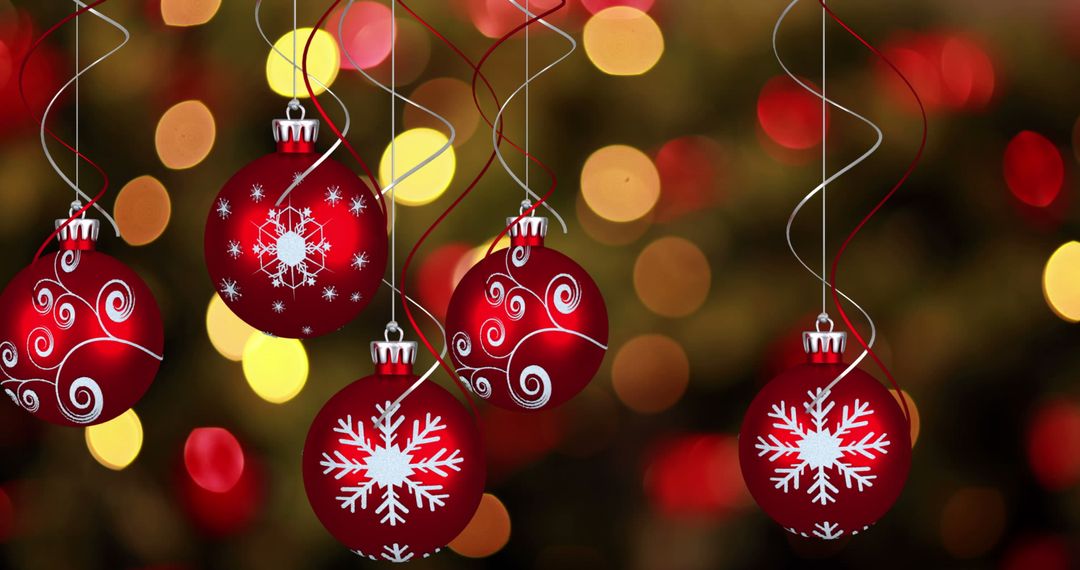 Red Christmas Baubles with Snowflakes and Patterns Against Festive Lights