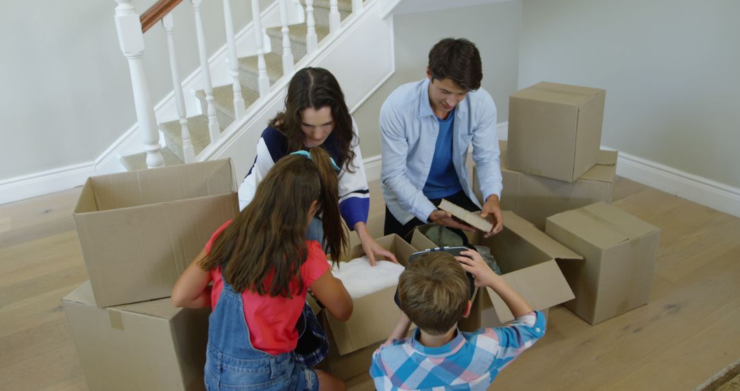 Family Unpacking Boxes in New Home with Children - Free Images, Stock Photos and Pictures on Pikwizard.com