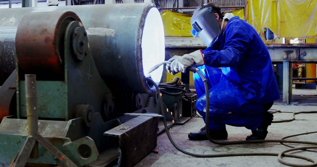 Industrial Worker Welding Large Metal Pipe in Factory - Free Images, Stock Photos and Pictures on Pikwizard.com