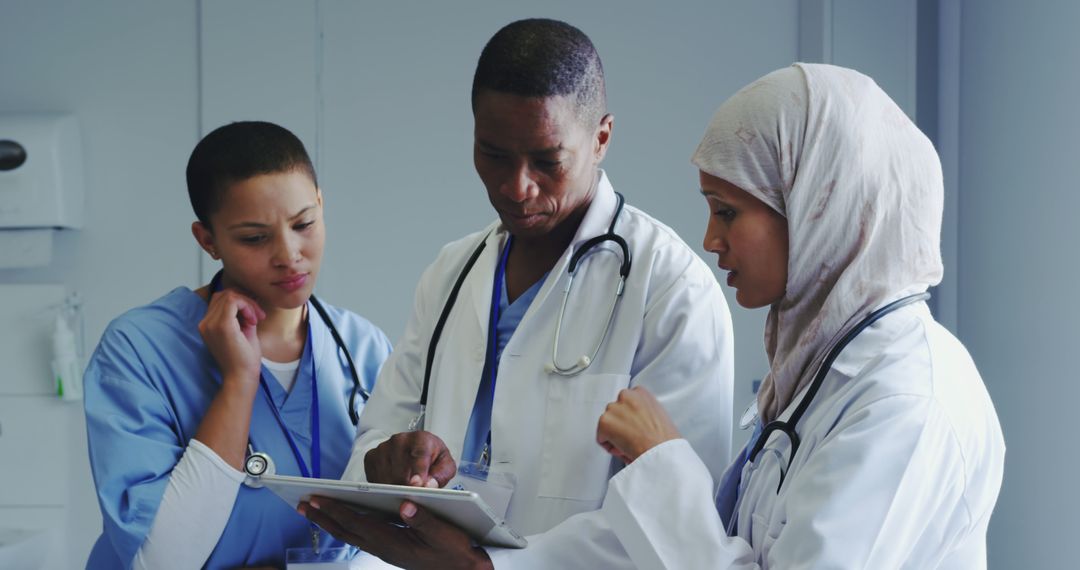 Diverse Medical Team Discussing Patient Records in Hospital - Free Images, Stock Photos and Pictures on Pikwizard.com