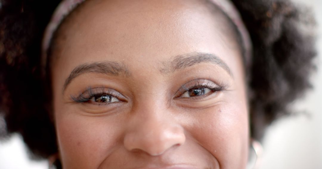 Close-Up of Smiling Woman with Natural Hair - Free Images, Stock Photos and Pictures on Pikwizard.com