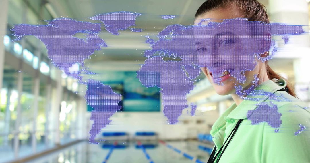 Female Swim Coach Smiling by Modern Indoor Lap Pool with Holographic World Map Overlay
