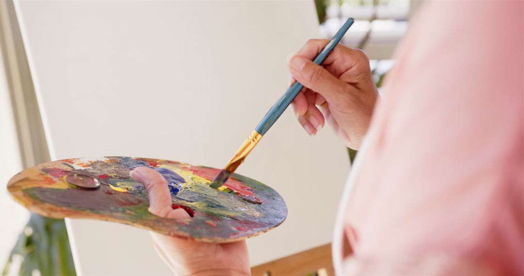 Artist Crafting Colorful Painting on Canvas
