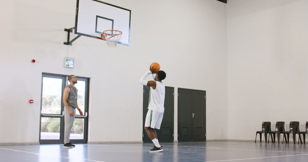 Diverse Athletes Practicing Basketball at Indoor Court