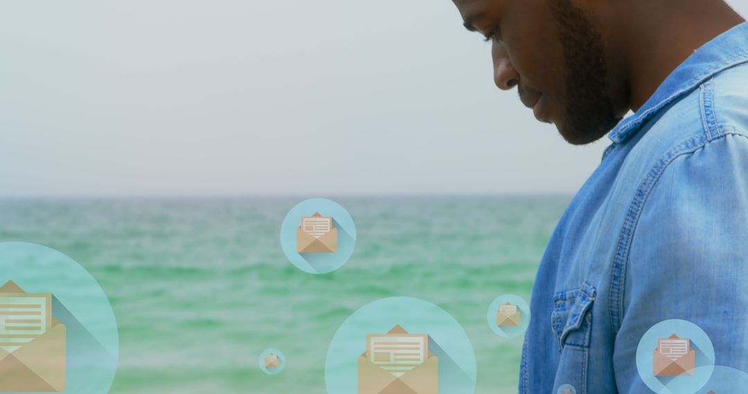 Man Checking Smartphone Beachside with Social Media Icons