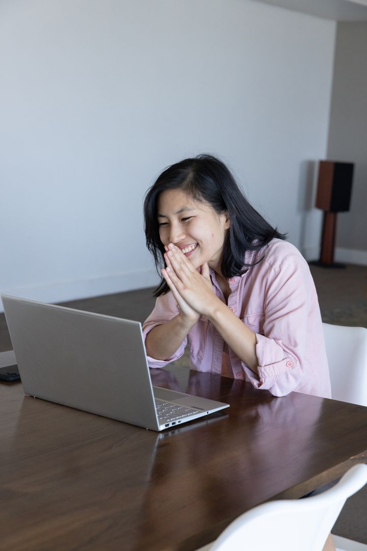 Cheerful Woman Engaged in Productive Remote Work at Home
