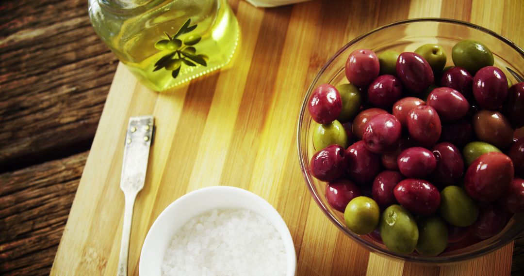 Fresh Olives with Olive Oil and Sea Salt on Wooden Board - Free Images, Stock Photos and Pictures on Pikwizard.com