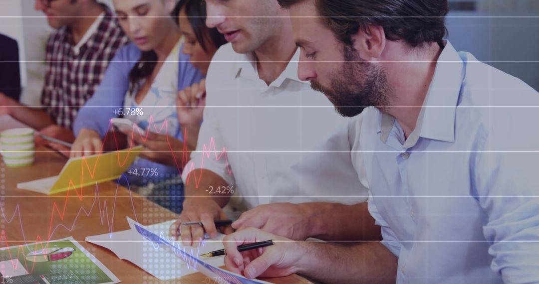 Team Analyzing Statistical Data in Modern Office Environment