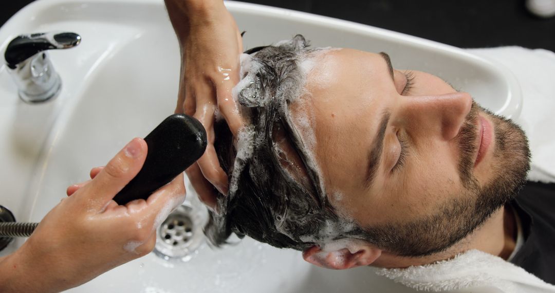 Man Enjoying Hair Wash at Salon by Professional Hairdresser - Free Images, Stock Photos and Pictures on Pikwizard.com