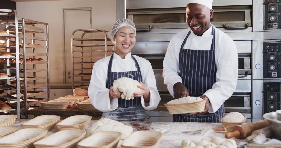 Diverse Bakers Smiling While Preparing Bread in Bakery - Free Images, Stock Photos and Pictures on Pikwizard.com