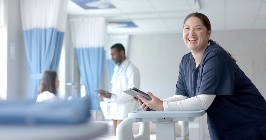 Smiling Female Doctor with Tablet in Hospital Ward