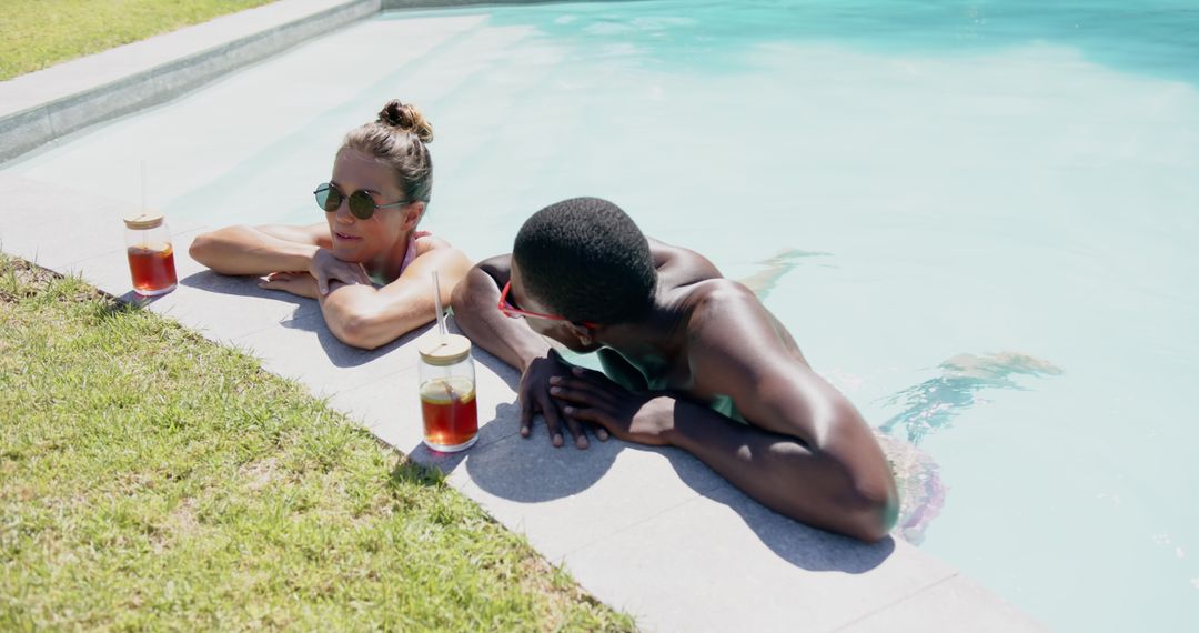 Diverse Friends Relaxing Poolside, Enjoying Refreshing Beverages