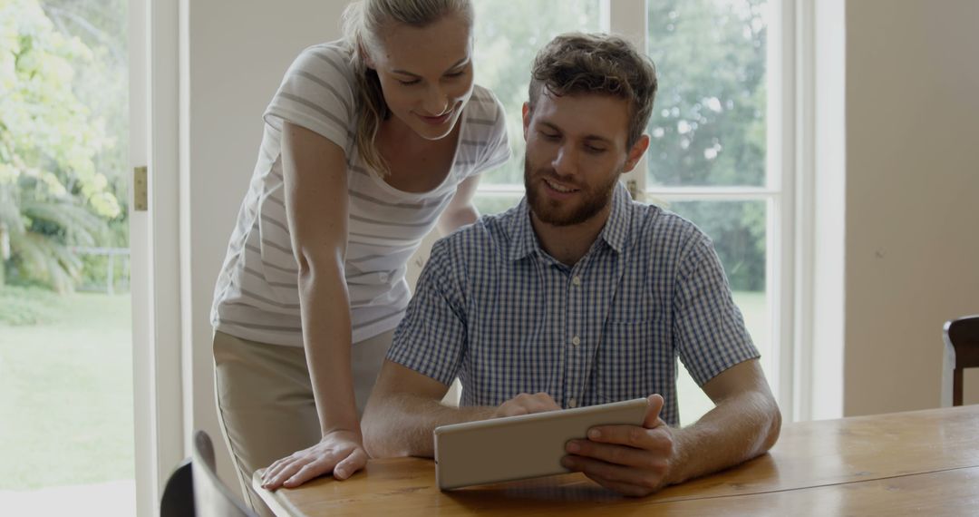 Couple Collaborating on Tablet in Modern Kitchen Setting
