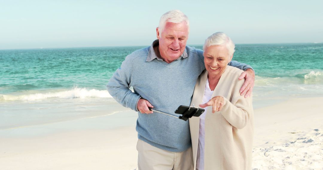 Smiling Senior Couple Taking Selfie on Beach - Free Images, Stock Photos and Pictures on Pikwizard.com