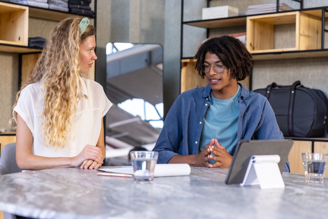 Diverse Professionals Discussing Ideas in Modern Office Environment