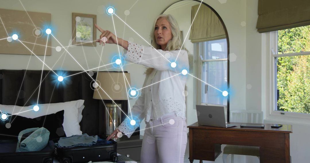 Senior woman interacting with augmented reality overlay in modern bedroom workspace