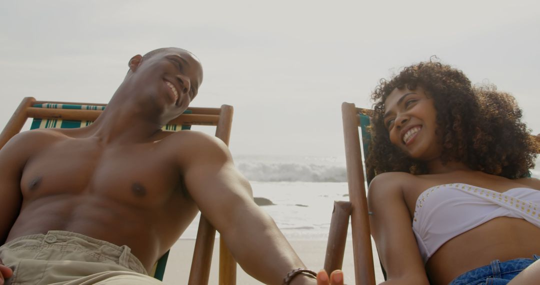 Happy Couple Relaxing on Beach in Summertime