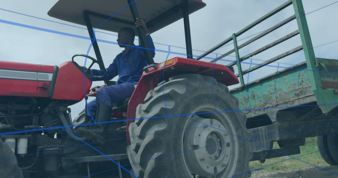 Farmer Driving Red Tractor with Green Trailer in Rural Field Setting