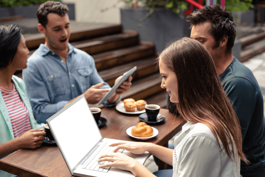 Coworking Group with Transparent Laptop at Outdoor Cafe