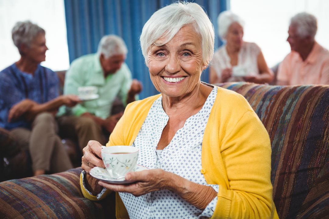Smiling senior woman holding a cup of coffee - Free Images, Stock Photos and Pictures on Pikwizard.com