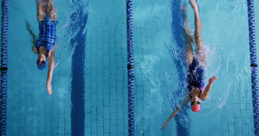 Two Female Swimmers Practicing Backstroke in Swimming Pool - Free Images, Stock Photos and Pictures on Pikwizard.com