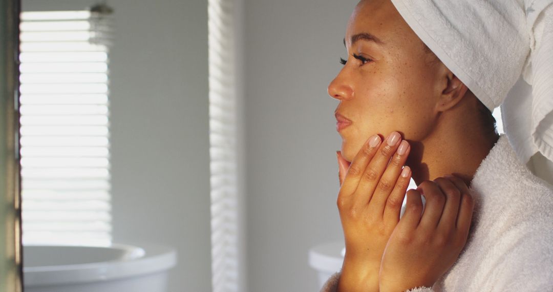 Woman Applying Skincare Routine After Shower in Bathroom - Free Images, Stock Photos and Pictures on Pikwizard.com