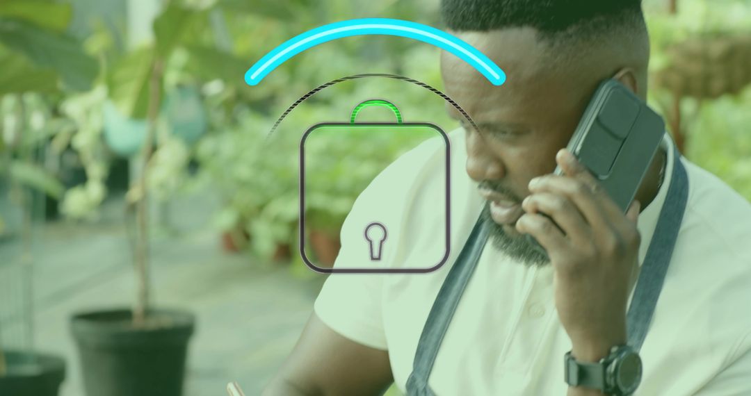Greenhouse Worker Using Technology Surrounded by Potted Plants
