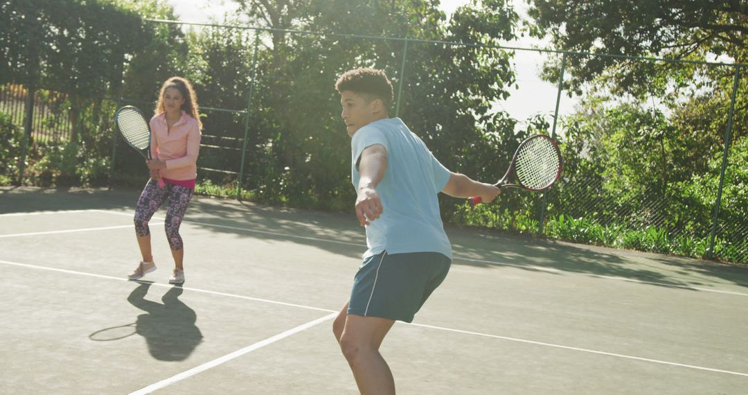 Two Friends Playing Tennis Outdoors on Sunny Day - Free Images, Stock Photos and Pictures on Pikwizard.com