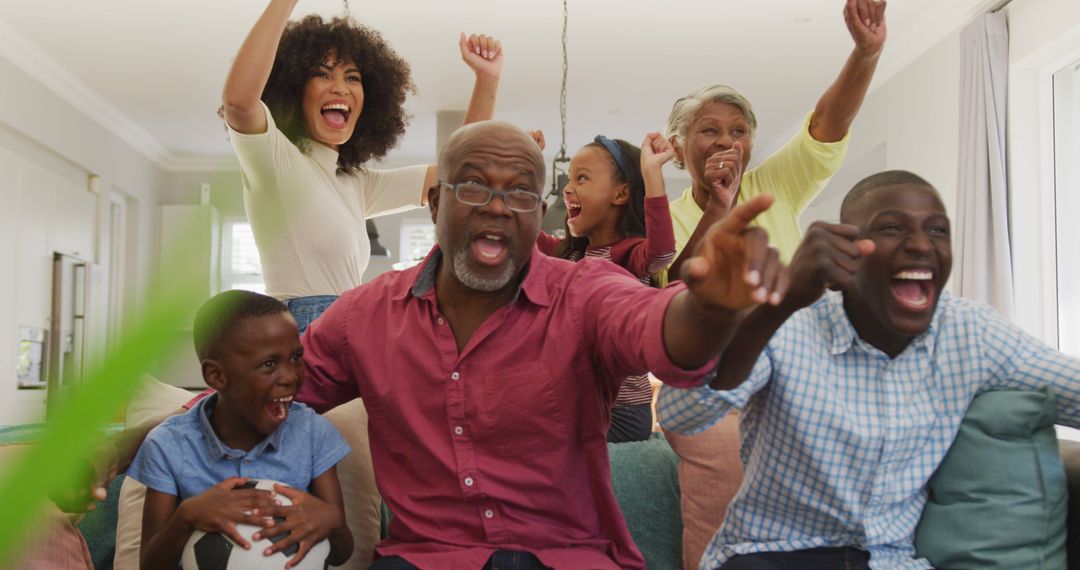 Image of happy african american family spending time together and watching football match - Free Images, Stock Photos and Pictures on Pikwizard.com