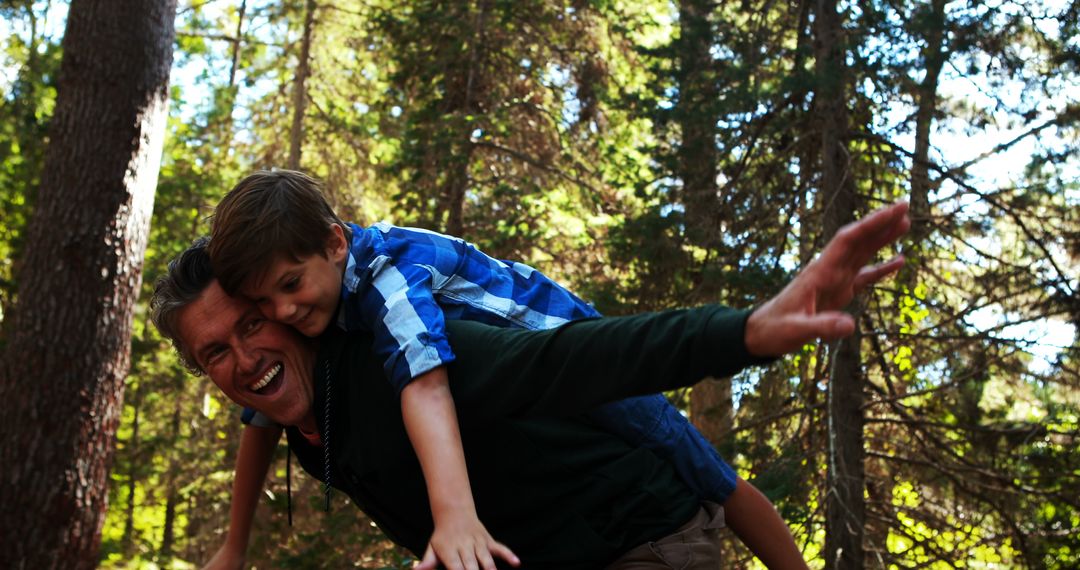 Father Carrying Son on Back in Forest, Smiling and Having Fun - Free Images, Stock Photos and Pictures on Pikwizard.com